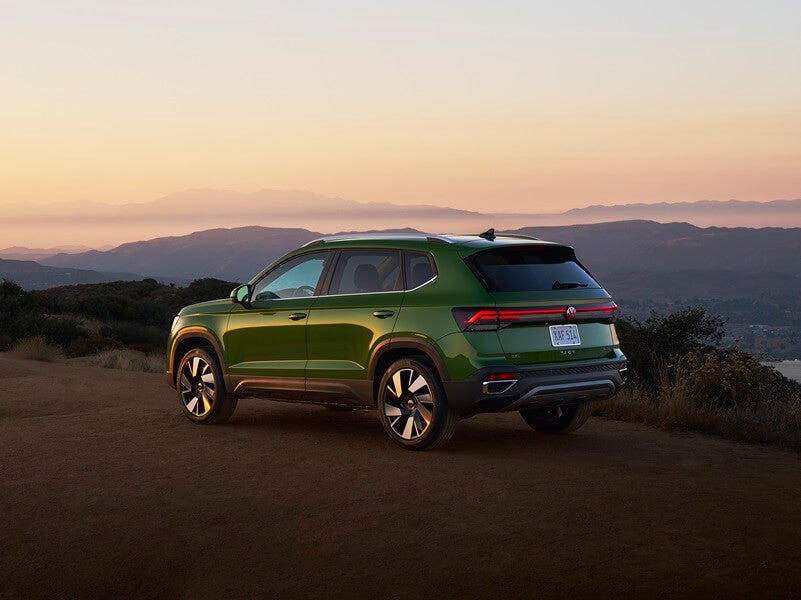 Volkswagen Taos parked on cliff overlooking sunset from Volkswagen Dealer near Laredo TX