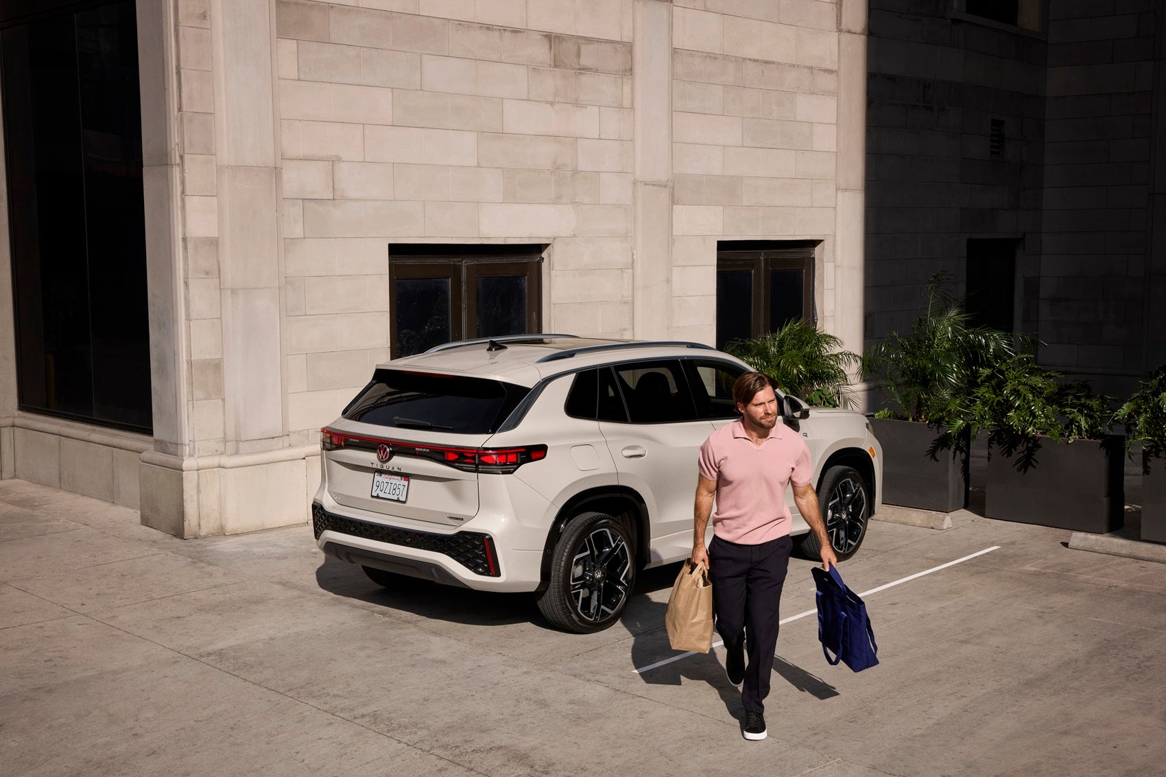 Man walking away from parked Volkswagen Tiguan from Volkswagen Dealer near Kingsville TX