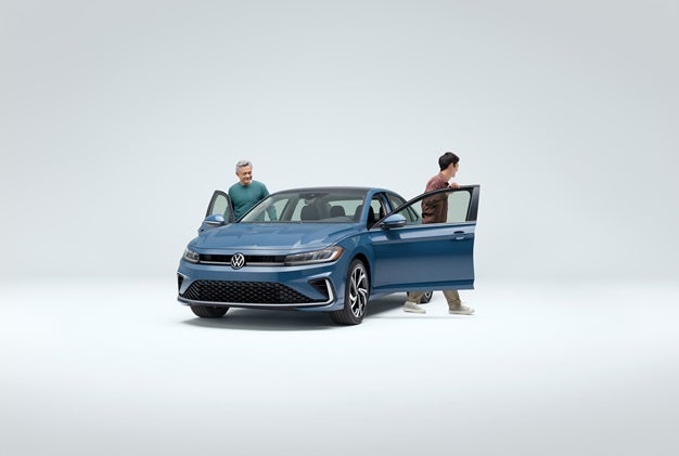 Two men next to the Volkswagen Jetta with the doors open near San Antonio TX 