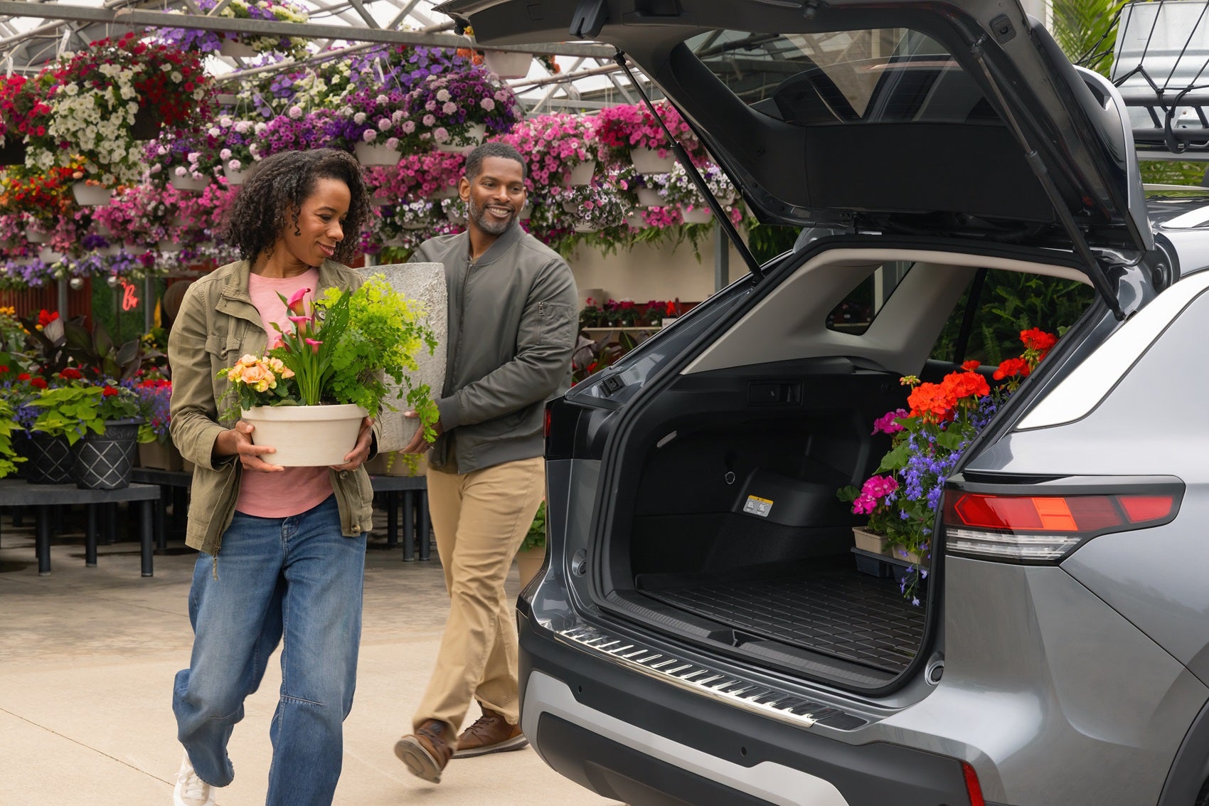 Couple at local floral shop loading flowers into truck of Volkswagen Tiguan from Volkswagen Dealer near Beeville TX
